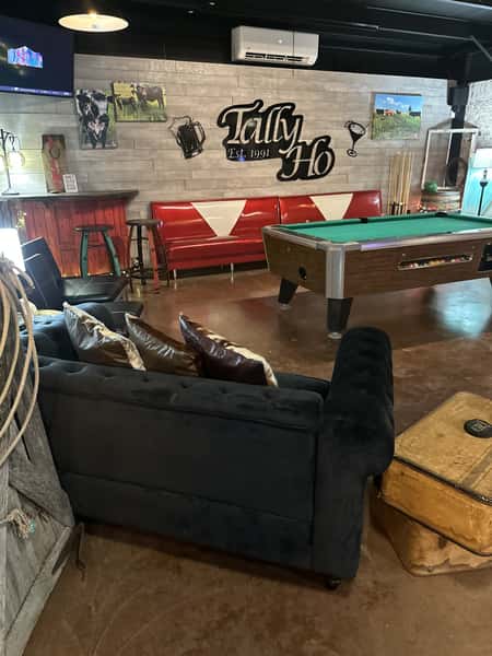 Restaurant interior with a pool table and red seats