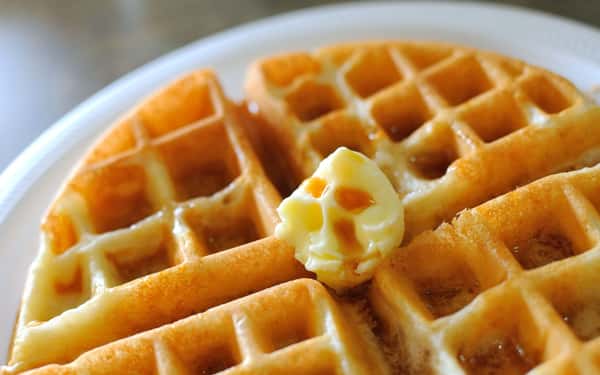 Waffle with syrup and butter on a plate