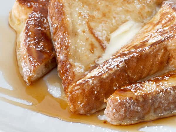 French toast sliced with butter and maple syrup