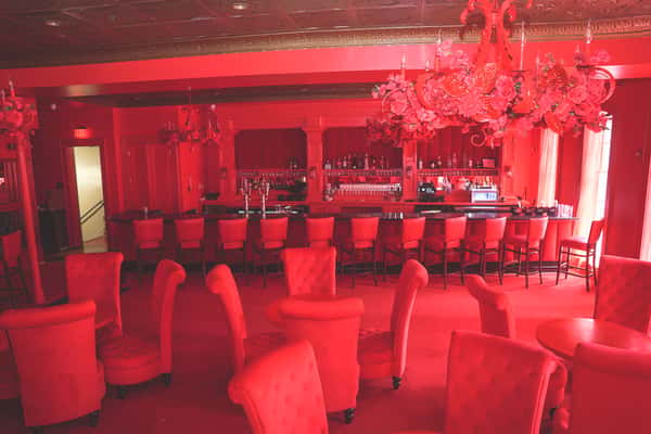 Picture of the room with the tables and the bar on the back