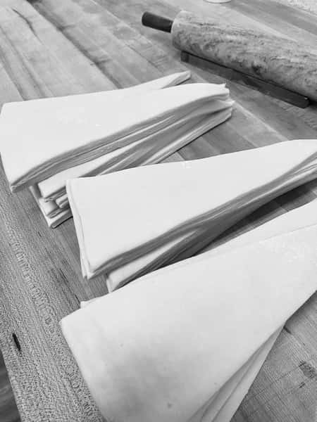 Croissants rolled by hand - one by one - no shortcuts.

Precisely cut. Carefully weighed. Every step done by hand to create the quality you can taste. 🥐

This is artisan baking at its best—made fresh every day and baked fresh for you.

Handmade. Fresh. Artisan.