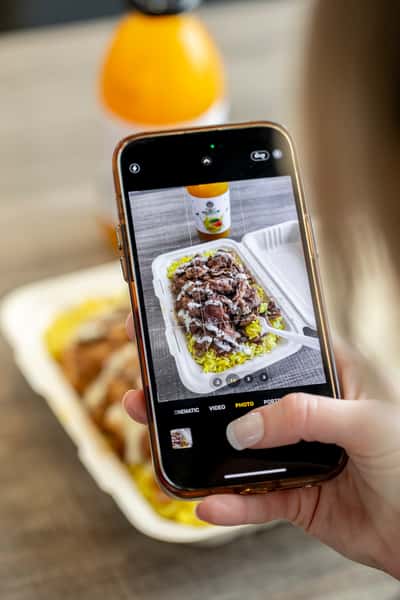 Foodie taking a photo of their food on their phone