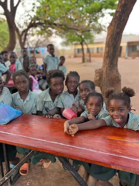 Smiling children holding cups