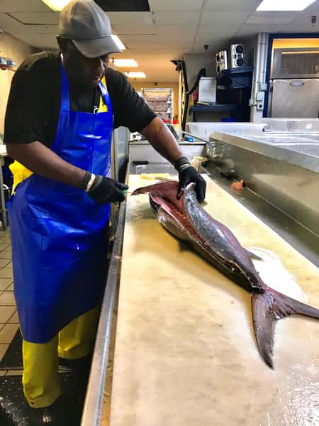 man cutting fish
