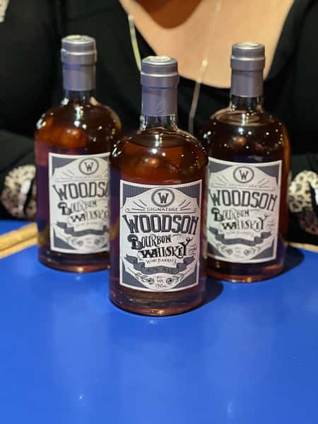 Woodson Whiskey bottles displayed behind the bar, highlighting premium American whiskey selections at Bobby Salazar's Mexican Restaurant & Cantina.