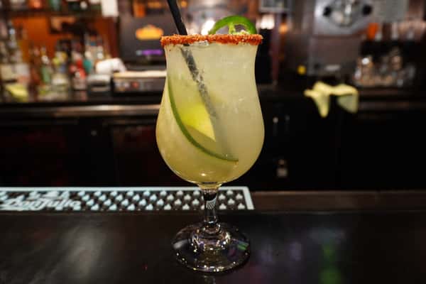 Handcrafted cucumber jalapeño margarita garnished with fresh cucumber and a Tajín-rimmed glass, served at Bobby Salazar's Mexican Restaurant & Cantina.