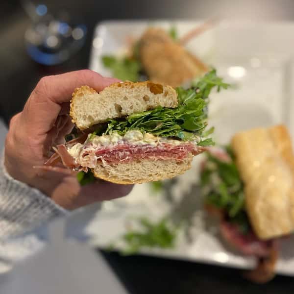 person holding a deli sandwich