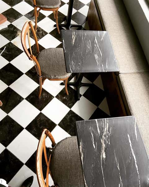 checkered floor with seats and tables