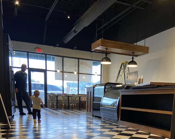 man and child walking through the inside of the business