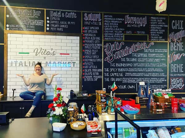 woman sitting on a counter top posing for a photo