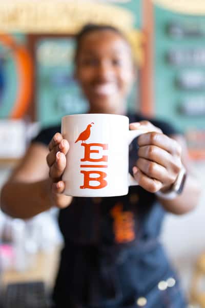holding a cup of coffee