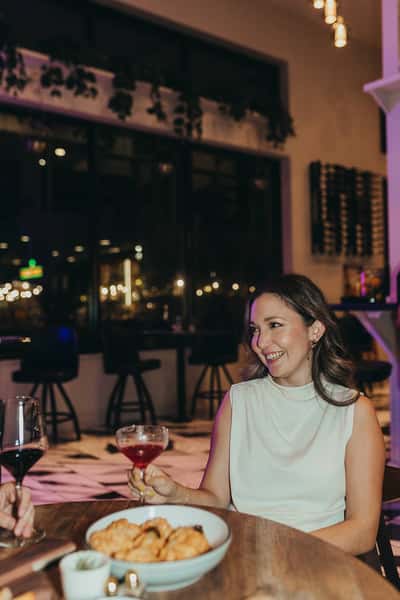 woman with a cocktail at dining table