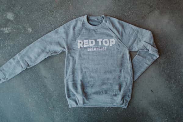 Long sleeve grey sweater with large white wordmark