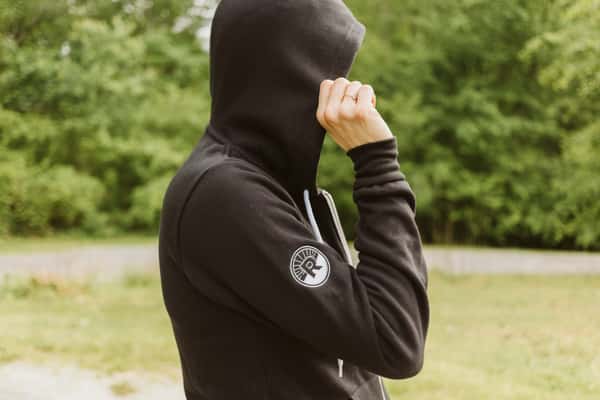zip up black hoodie with wordmark on left breast and circle R logo on sleeve