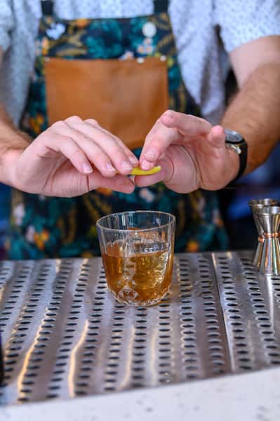 bartender garnishing a cocktail