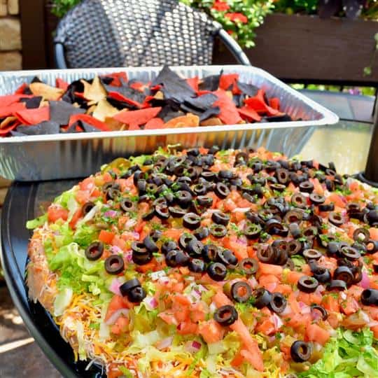 pizza with olives, tomatoes, and lettuce