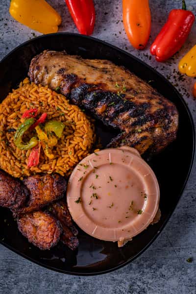 Grilled Beef Ribs with side of fried rice, moi moi and plantains