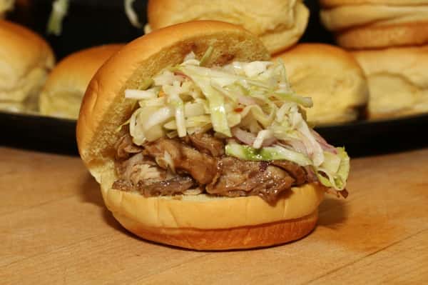 Pulled pork on a roll and topped with coleslaw