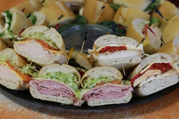 A tray filled with various pre-made sandwiches