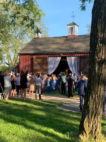 A catering event with guests walking into the barn