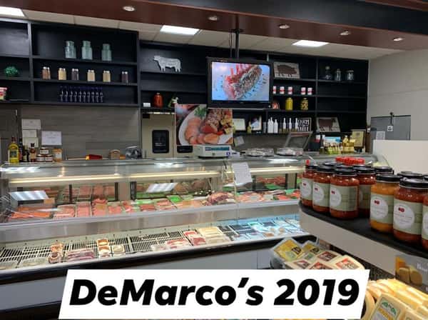 The inside of DeMarco's in 2019. Brand new front counter with display cases of food and many selves of products