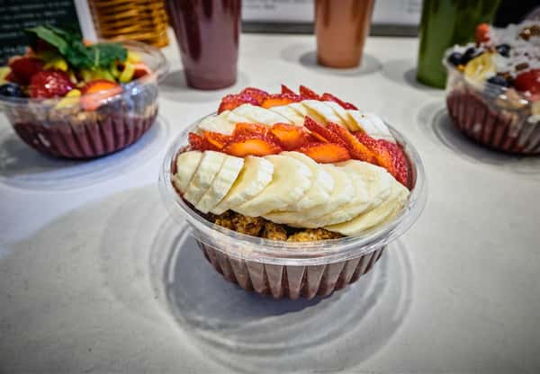 Acai bowl topped with strawberries and bananas