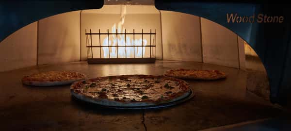 Pizzas cooking in an oven