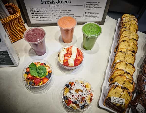 Assortment of acai bowls and smoothies with an assortment of marble cake