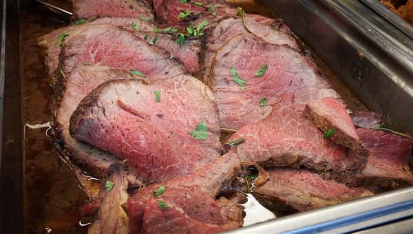 Assortment of sliced meat topped with garnish