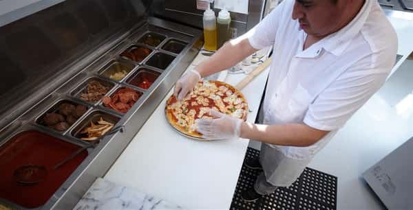 Chef making a pizza in the kitchen
