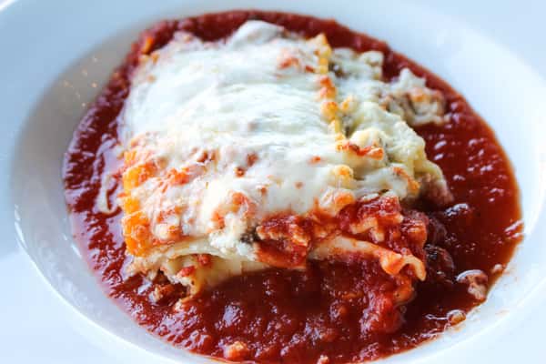 layers of pasta, meat sauce, ricotta + melted mozzarella cheese