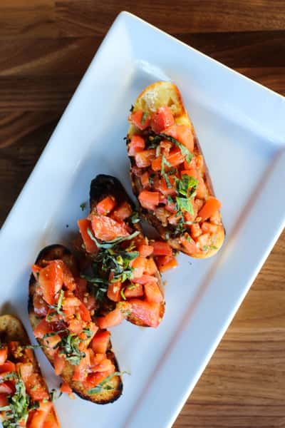 tomato, evo, garlic + red onion served over toasted foccacia