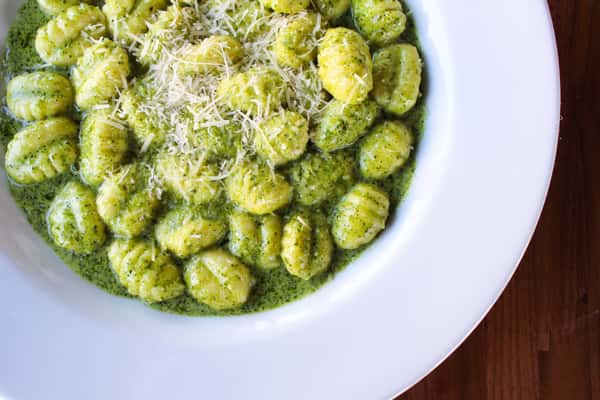 potato gnocchi served with pesto cream sauce