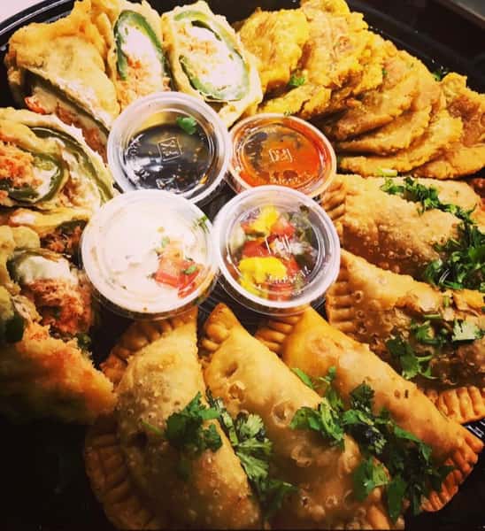 Empanadas, tostons, jalapeno tempura, and their coordinating sauces