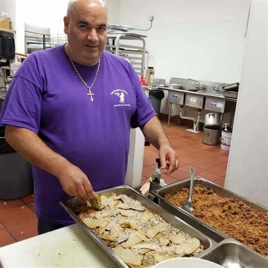 male employee in kitchen preparing food