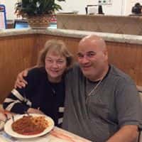 male and female smiling for a pizza