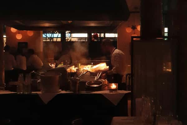 Chef in a dark, warmly lit room