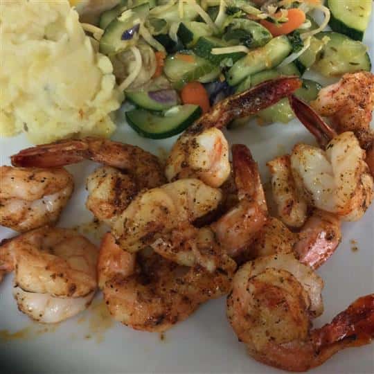 Seasoned blackened shrimp with a sid eof vegetables and mashed potatoes