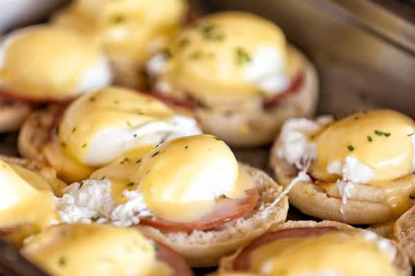 Close-up of eggs benedict topped with hollandaise sauce