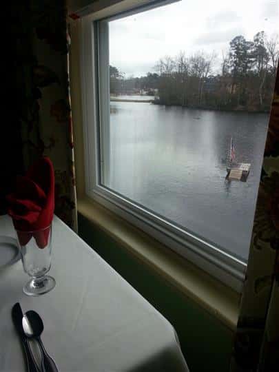 View of lake from a window by a table