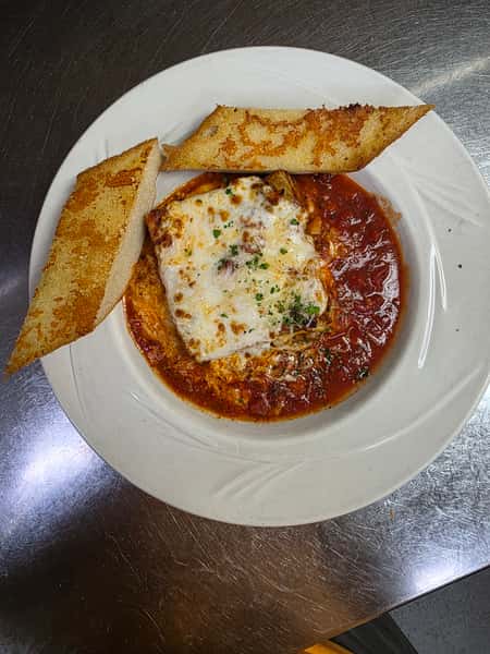 House-made lasagna with meat sauce and melted mozzarella, served with garlic bread at Collectors Choice Restaurant in Snohomish.