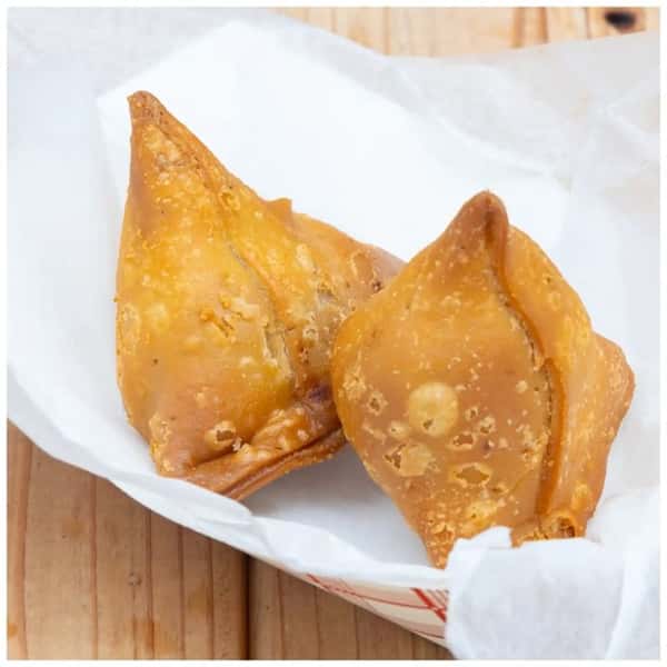 Golden crispy fried dumplings served in a paper-lined basket, crunchy Asian-style appetizer.