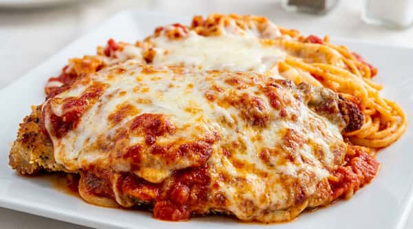 Chicken parmesan topped with melted cheese and marinara sauce served with pasta at Roger's Family Restaurant in Somerset MA