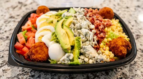 Fresh Cobb salad with avocado, bacon, blue cheese, eggs, tomatoes, and crispy chicken at Roger's Family Restaurant in Somerset MA