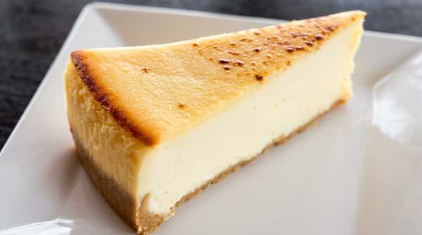 Classic cheesecake slice with creamy filling and graham cracker crust at Roger's Family Restaurant in Somerset MA