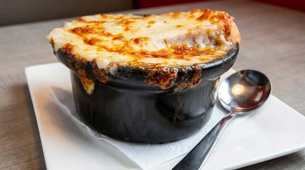 Classic French onion soup with melted cheese and rich savory broth at Roger's Family Restaurant in Somerset MA