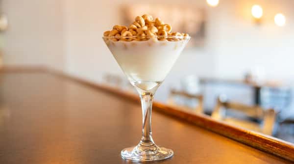 Creamy dessert cocktail topped with cereal garnish at Roger's Family Restaurant in Somerset MA