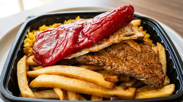 Portuguese-inspired steak plate with fries, rice, and roasted pepper served at Roger's Family Restaurant in Somerset MA
