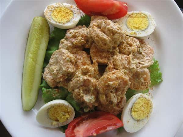 Boiled eggs with sliced pickle and tomatoes