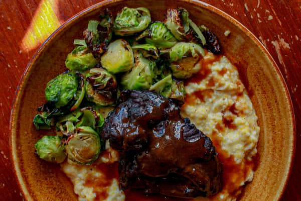 braised bbq pork, cheesy grits, and brussel sprouts